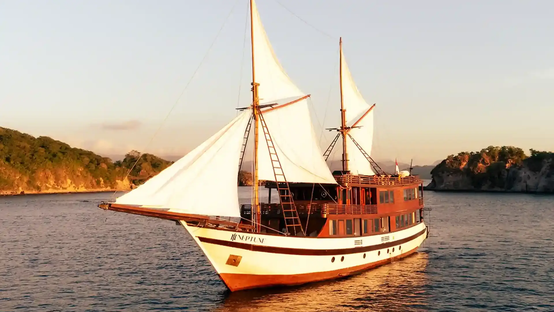 Phinisi sailing at golden hour