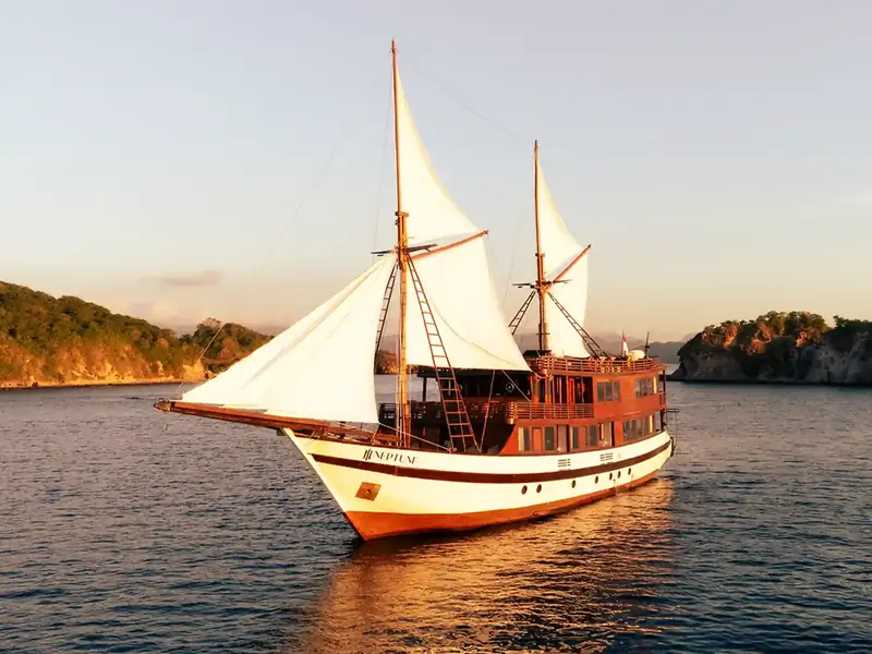 Phinisi sailing at golden hour