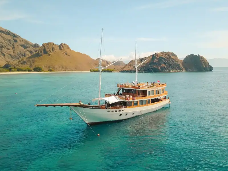 Phinisi anchored in turquoise water