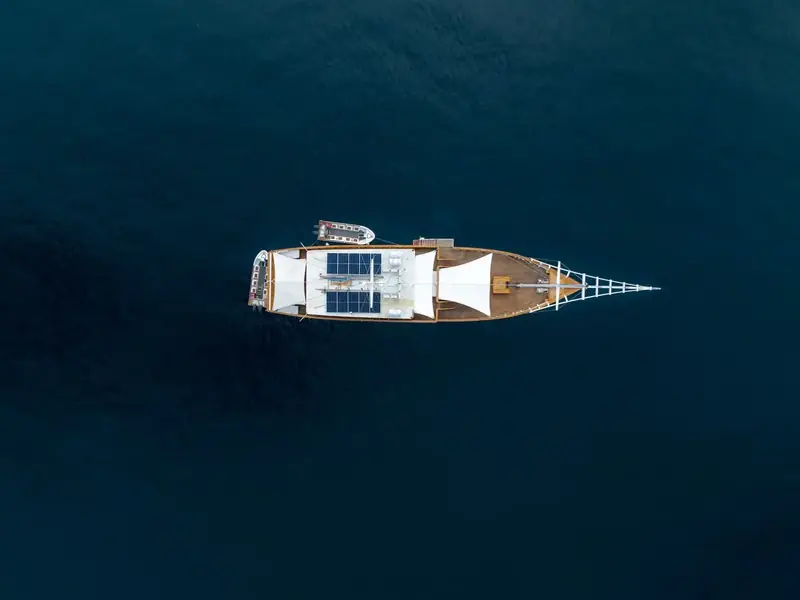 Phinisi seen from directly above on deep blue water