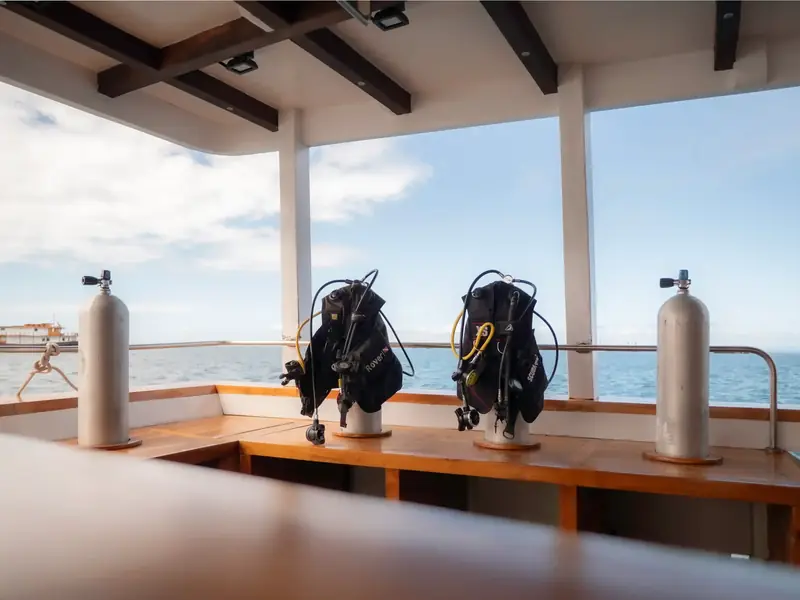 Dive tanks and gear ready on a phinisi deck